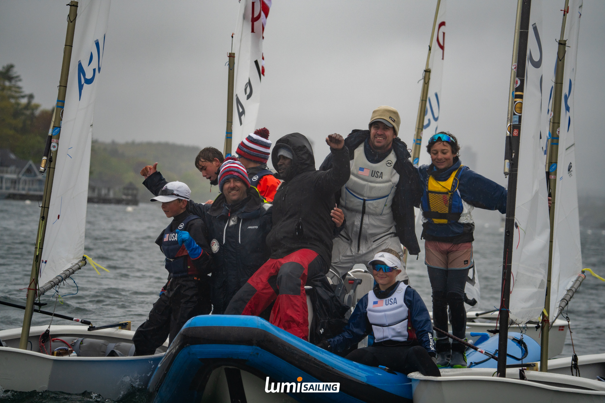 Sailors celebrating together after a wet regatta